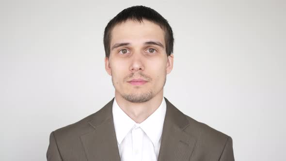 Closeup Portrait of a Surprised Confused Shocked Businessman with Brown Eyes Looking Into the Camera