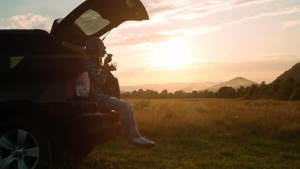 Casual Traveler Eating Lunch at Sundown