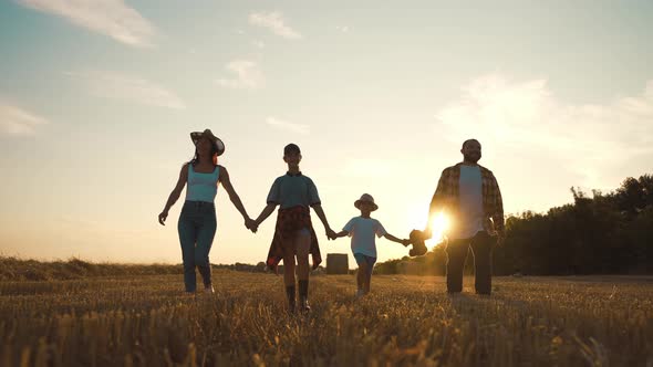 Happy Family Silhouette Walk at Sunset