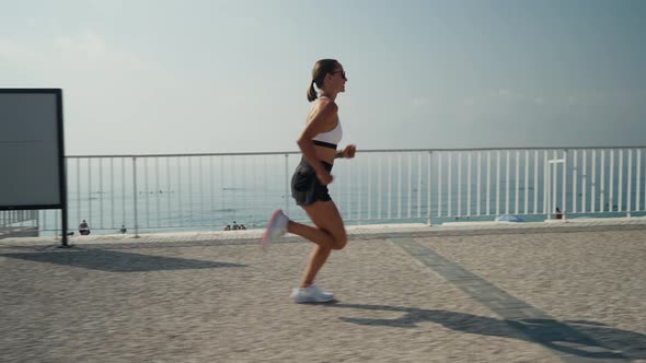 Young Caucasian Woman Running at Seaside