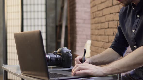 Cropped Male Photographer Uses a Graphics Tablet