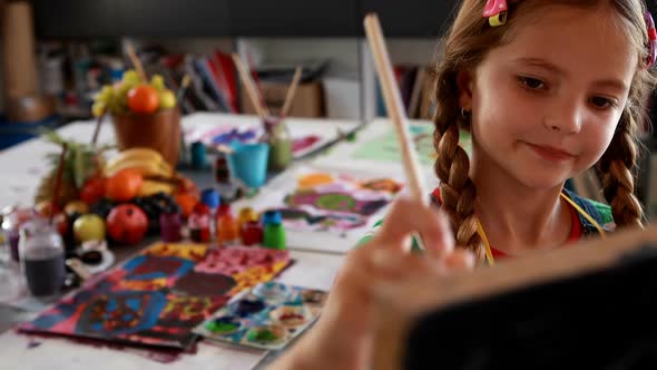 Cute schoolgirl painting on canvas 4k