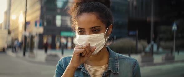 Front view video of woman coughing in a protective mask. Shot with RED helium camera in 8K.