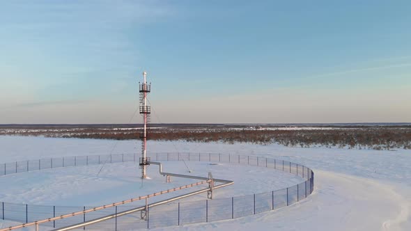 A Drone Flies Over an Emergency Gas Release Tower at an Oil and Gas Refinery