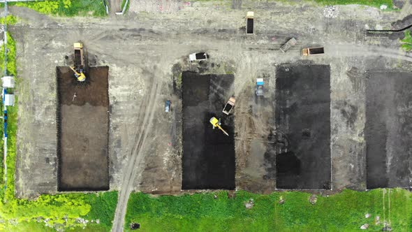 Aerial view of the construction site. Special machinery digs a pit. Work machinery.