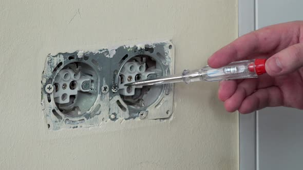 Hand Unscrew Outlet and Test It with Voltage Test Lamp Screwdriver