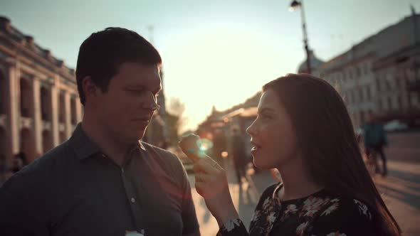 Happiness Couple with Ice Cream Under Sunlight