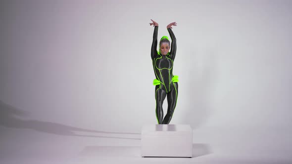 Wide Shot Portrait of Confident Gymnast in Futuristic Costume Doing Front Walkover and Looking at