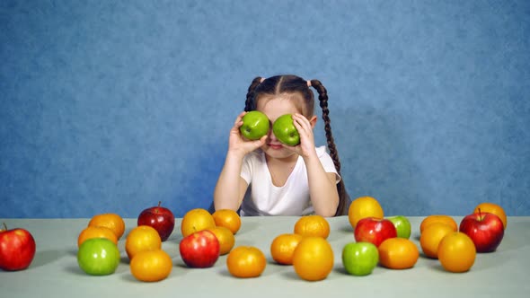 Little girl with fruit. Happy child girl and lot of fruit