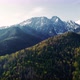 Aerial view of high mountains in summer or spring. Peaks are still covered with snow. - VideoHive Item for Sale