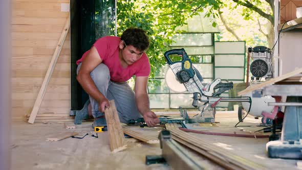 Carpenter cutting wood for house construction