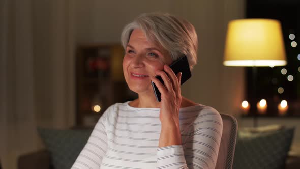 Old Woman Calling on Smartphone at Home at Night