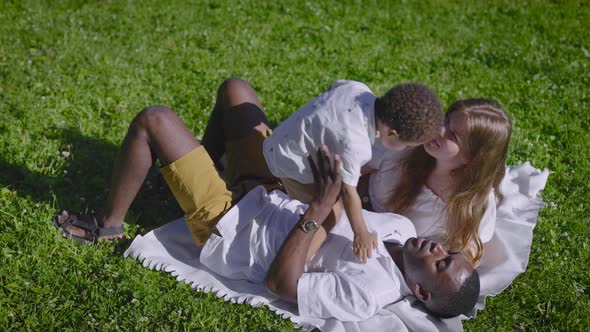 A Multicultural Family Lies in the Park