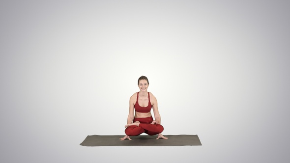 Young sporty woman practicing yoga doing Scale exercise,