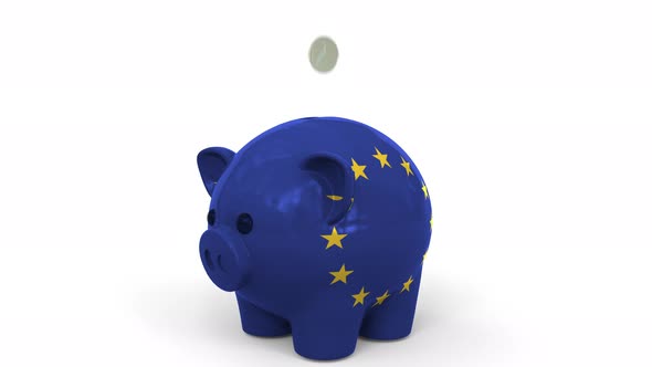 Coins Fall Into Piggy Bank Painted with Flag of the EU alt