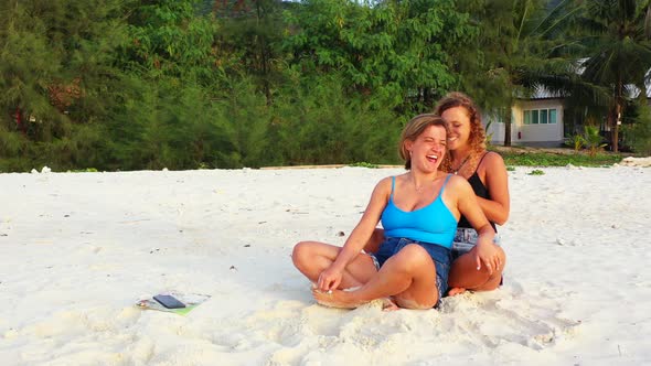 Beautiful beauty models on holiday spending quality time at the beach on paradise white sand and blue