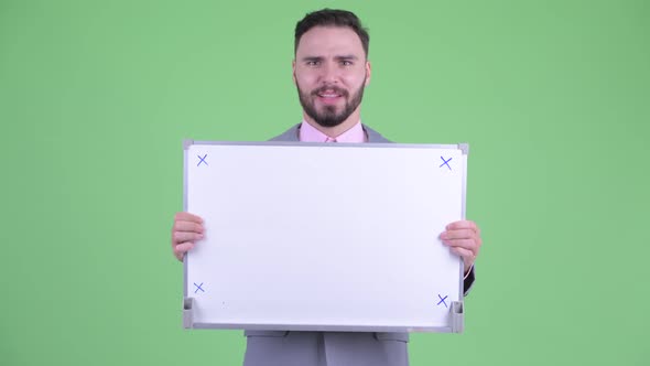 Happy Young Bearded Businessman Holding White Board and Getting Good News