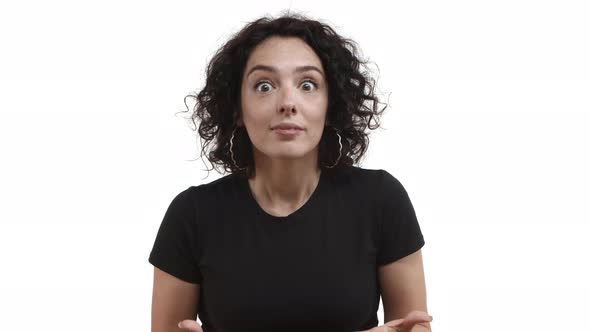 Video of Attractive Caucasian Woman with Dark Curly Hair and Black Tshirt Hear Fantastic News