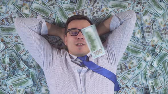 Portrait Satisfied Male Businessman in Business Clothes Lays Down on Banknotes