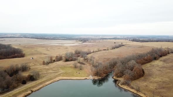 Flying over huge lake in empty fields Missouri.