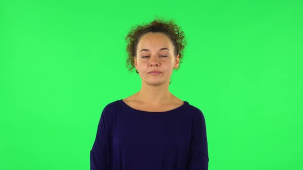 Portrait of Curly Woman Standing Waiting with Boredom. Green Screen