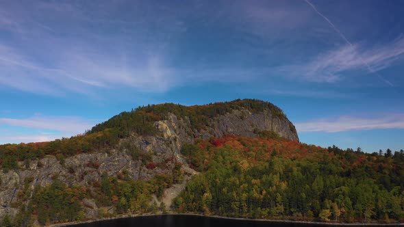 Aerial pull away from Kineo Mountain over Moosehead lake in autumn
