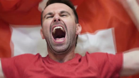 Swiss Fan Celebrates Holding the Flag of Switzerland