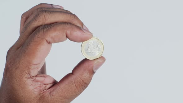 Hand Holding Euro Coin