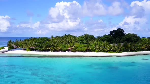 Aerial drone scenery of resort beach by blue ocean with sand background