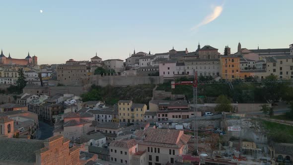 Historical Buildings and a Modern Crane at the Construction Site in Toledo
