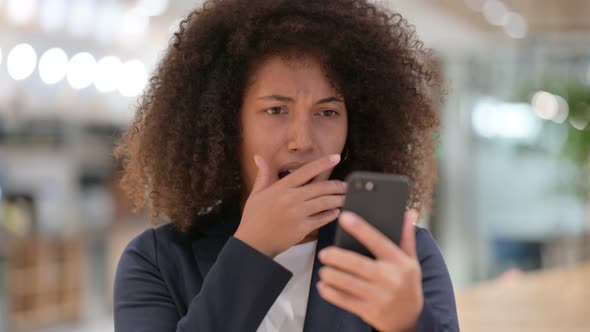 Young African Businesswoman Reacting To Loss on Smartphone 