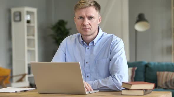 Disliking Businessman Denying By Shaking Head at Work