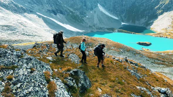 Group of people are traveling in the mountains with a guide