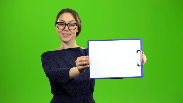 Accountant Raises a Paper Tablet and Smiles. Green Screen