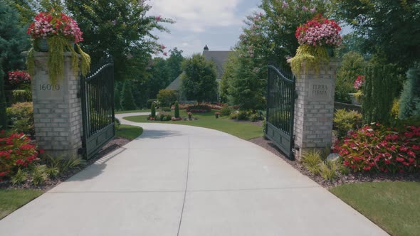 Beautiful footage of the entrance to an enormous mansion on a bright sunny day