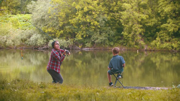 Two Brothers on Fishing - Big Brother Throws Fishing Rod in the Lake