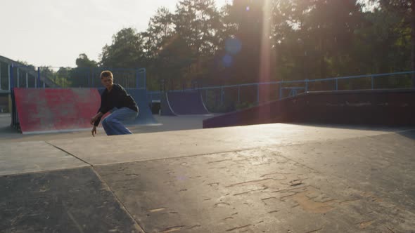 Teen Skating on Ramp and Doing Kickflip