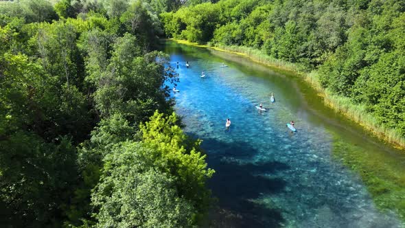 People in harmony with nature. Relaxing holiday on a lake. Clear water reflects