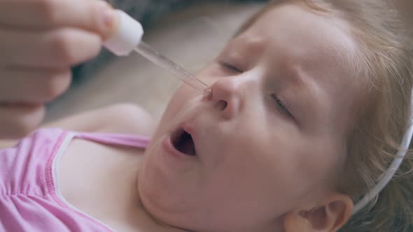 Cute Girl Undergoes Nasal Instillation Procedure on Bed