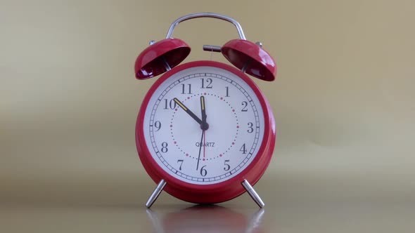 Red alarn clock with a fast second hand .