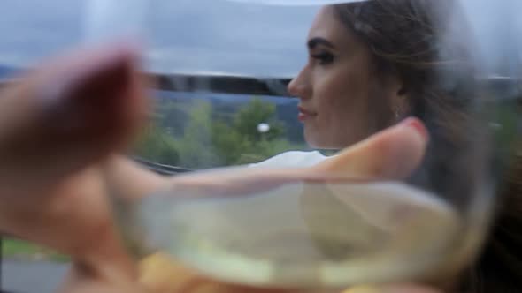 the Girl Drinks White Wine Sexy Young Woman with Glass of Wine