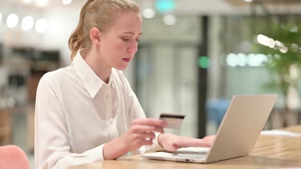 Young Businesswoman Making Successful Online Payment on Laptop