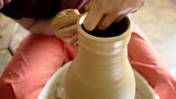 Experienced Potter Creating a Beautiful Clay Vase Using Professional Tools