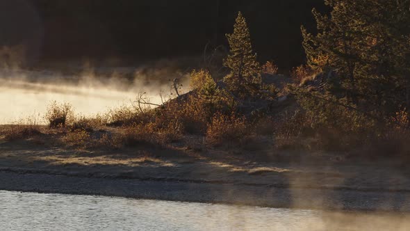 Panning view of steam rising at sunrise from the Snake River