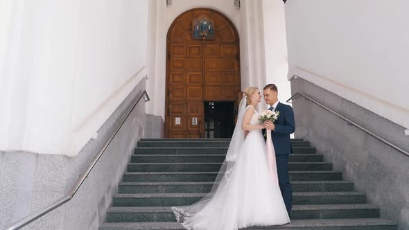 Bride and Groom Embracing in Park