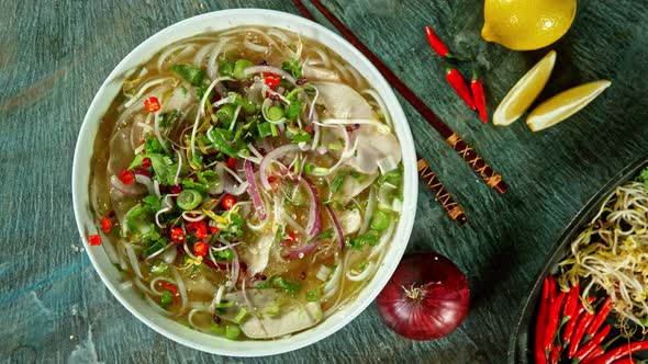 Super Slow Motion Shot of Chicken Slices Falling Into Pho Soup at 1000 Fps.