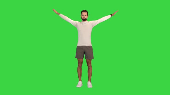 Healthy Man Rotating Hands to Warm Up Shoulders on a Green Screen Chroma Key