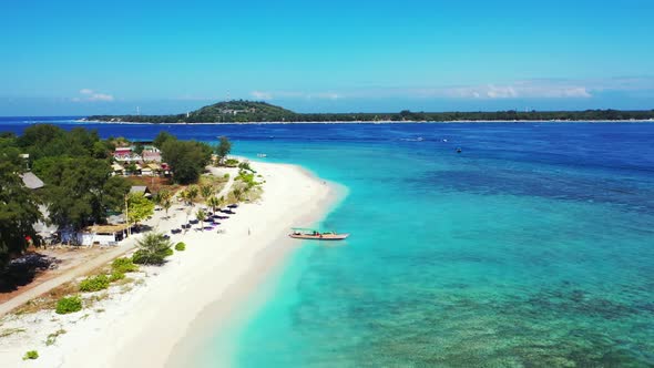 Aerial flying over seascape of paradise shore beach adventure by blue green lagoon and clean sand ba