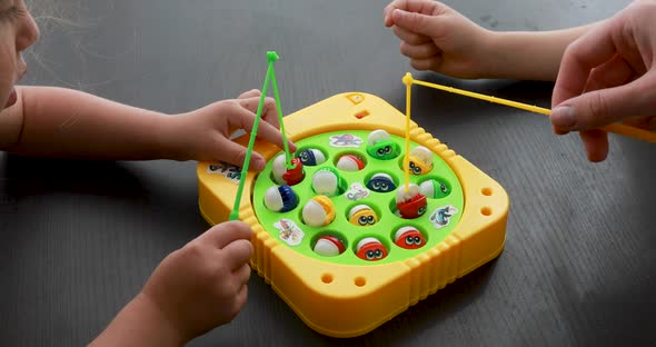 Kids Play with Artificial Fishing Game Catching Small Fish