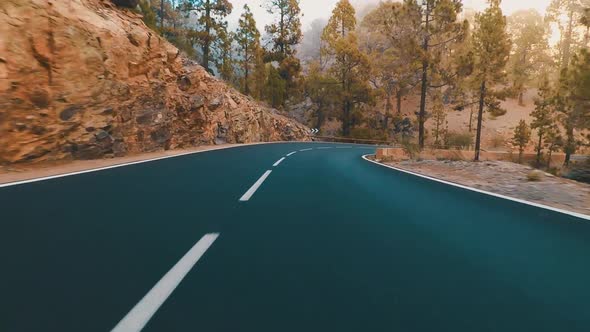 Long asphalt road ground view with sunset light and travel concept - mountain and sky